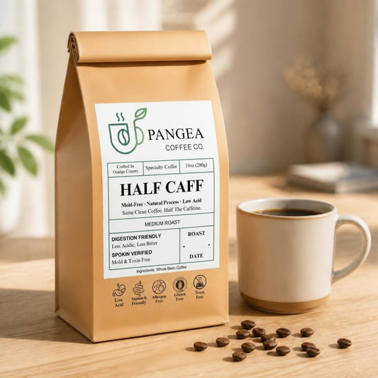 Pangea Half Caff low acid mold-free medium roast coffee, 10oz bag beside a mug, half the caffeine with full flavor