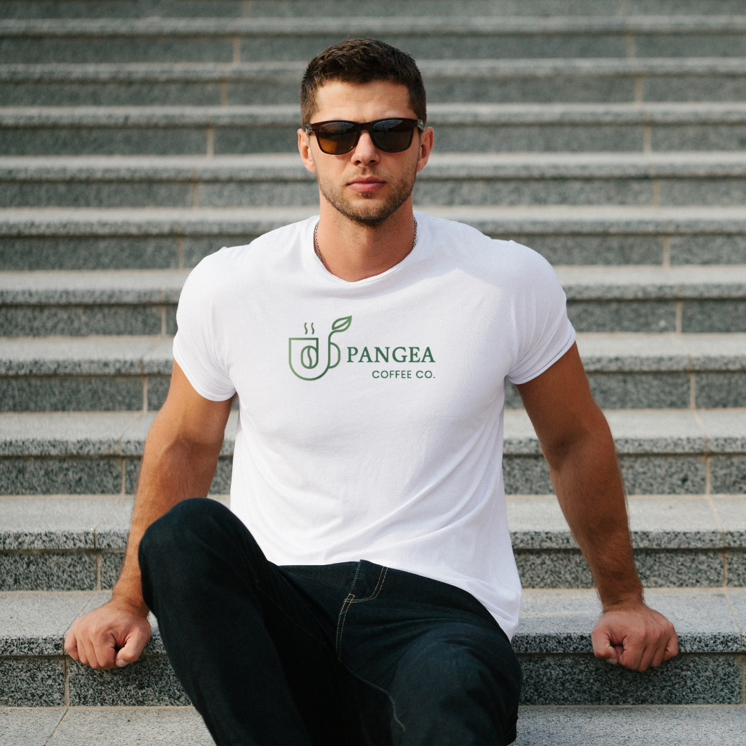 Man wearing the Pangea Coffee unisex graphic tee in charcoal gray, holding a coffee mug — modern, relaxed fit design inspired by clean coffee and sustainable living.