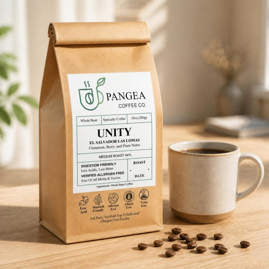 Pangea Unity El Salvador Las Lomas low acid medium roast coffee, 10oz bag beside a mug, cinnamon, berry and plum notes, mold-free