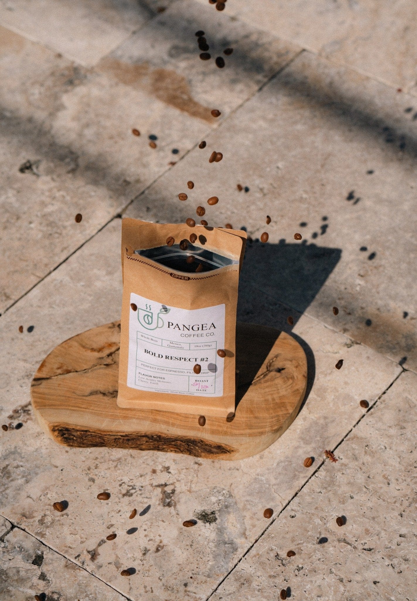 Action shot of Pangea Coffee beans being tossed into the air – fresh, whole beans scattered in mid-air against a clean background, capturing energy and quality.