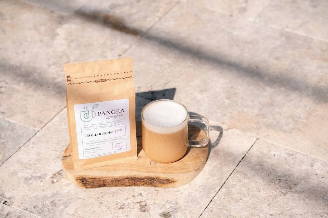 Pangea Coffee bag beside a cup of espresso — low acid, mold-free specialty coffee