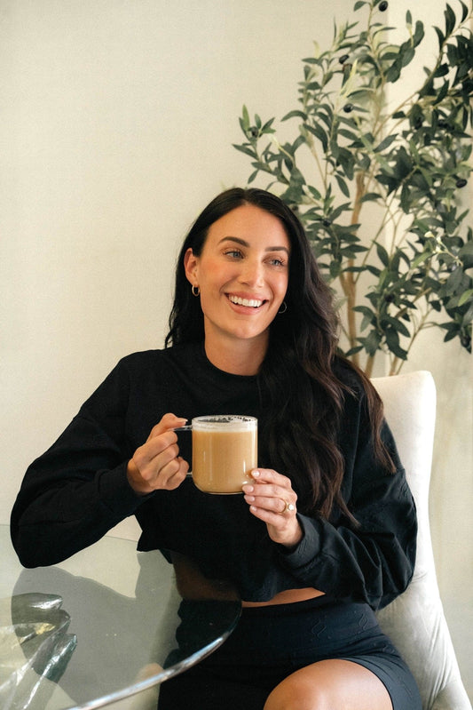 Woman enjoying Bold Respect low acid espresso without heartburn or acid reflux - stomach friendly coffee