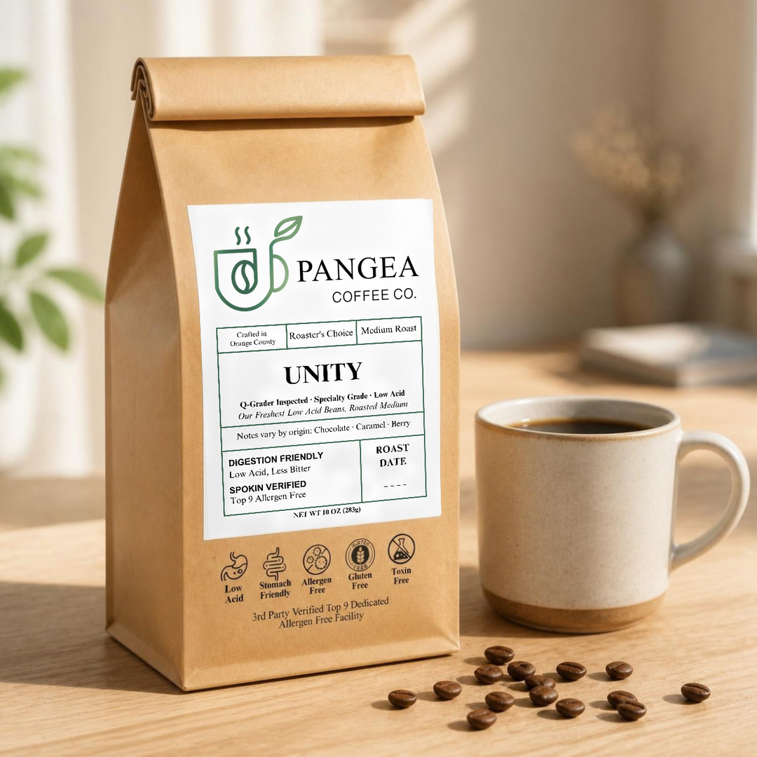 Pangea Unity low acid mold-free medium roast coffee, 10oz bag beside a mug of drip coffee, smooth all-day coffee for sensitive stomachs