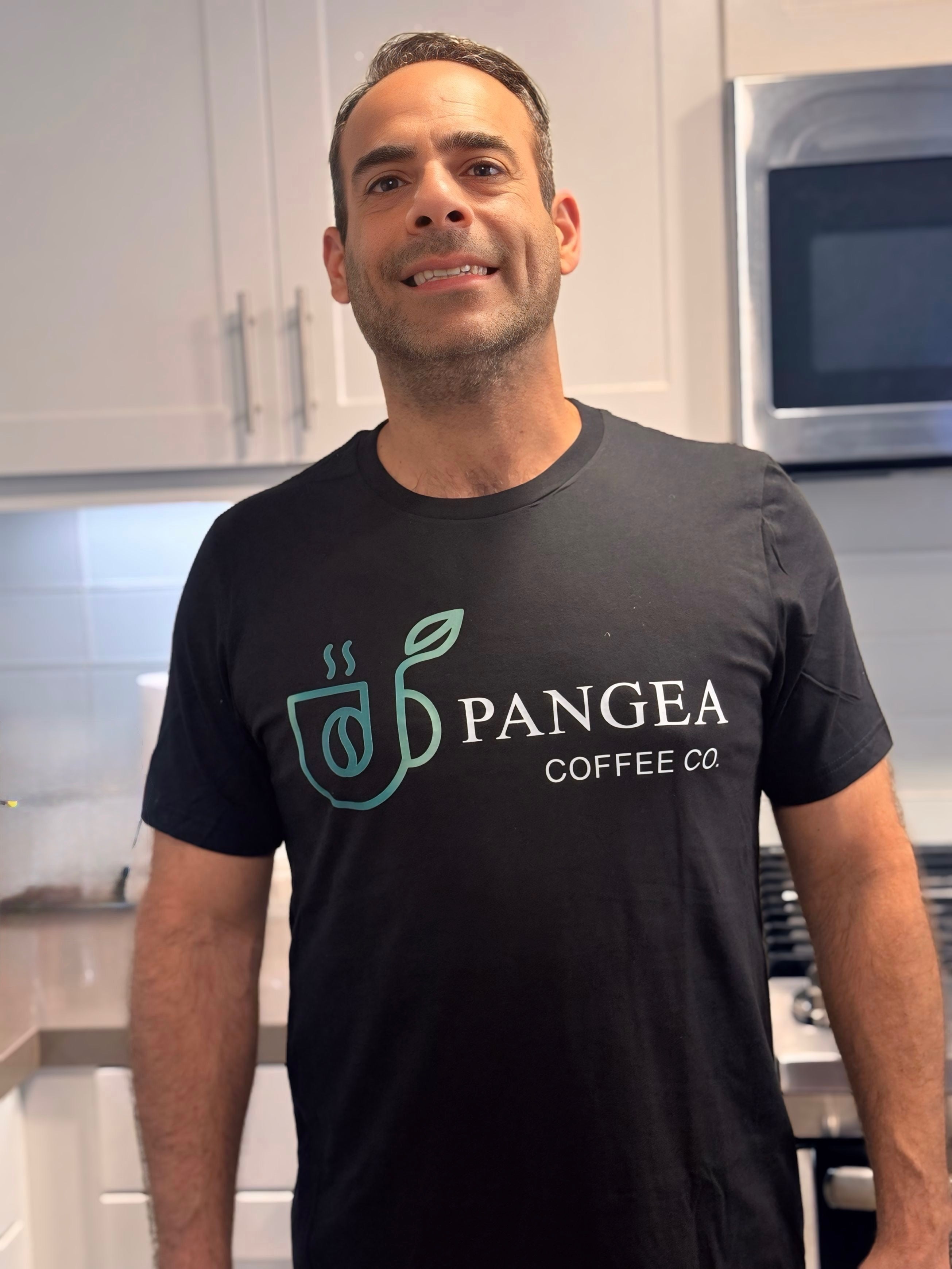 Founder wearing Pangea Coffee black unisex tee with brand logo